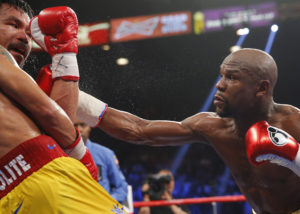 Pacquiao of the Philippines ducks a punch from Mayweather, Jr. of the U.S. in the seventh round during their welterweight title fight in Las Vegas