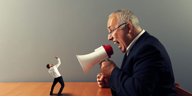 boss screaming at small businessman